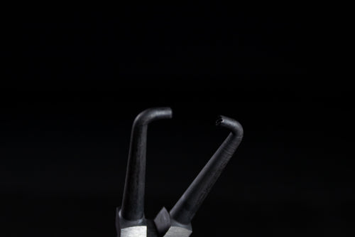 Prying with a screwdriver snaps tabs