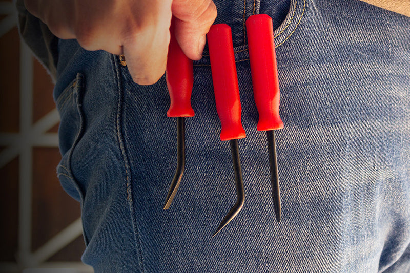 Three Olsa Tools Pocket Pry Bars in a pocket.